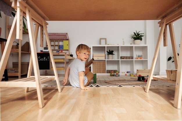 Adorable child playing with toy full shot