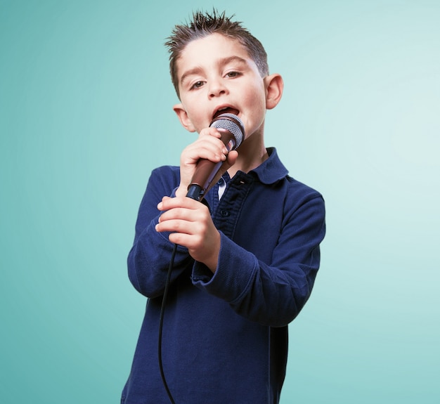 Adorable child singing with a microphone