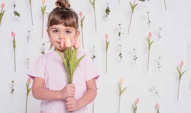 Free photo adorable child with tulips medium shot