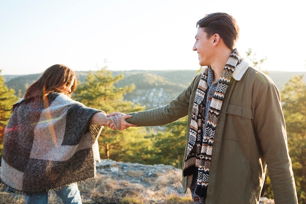 Free photo adorable couple holding hands outdoors