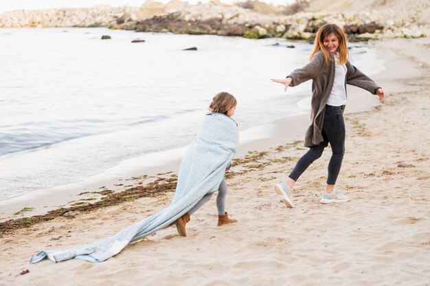 Adorable daughter and mother enjoying outdoors