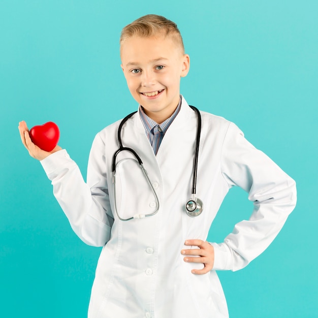 Free Photo adorable doctor holding heart front view