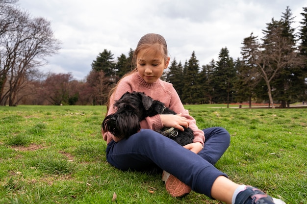 Free photo adorable dog at the park in nature with owner