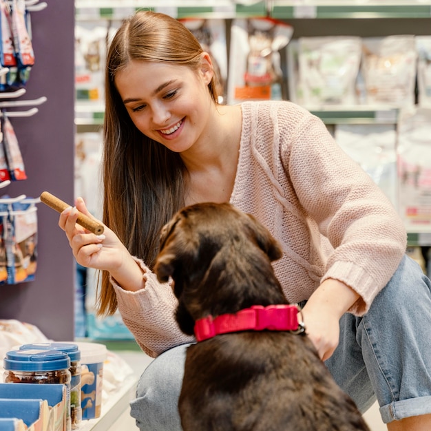 Adorable dog with female owner at the pet shop