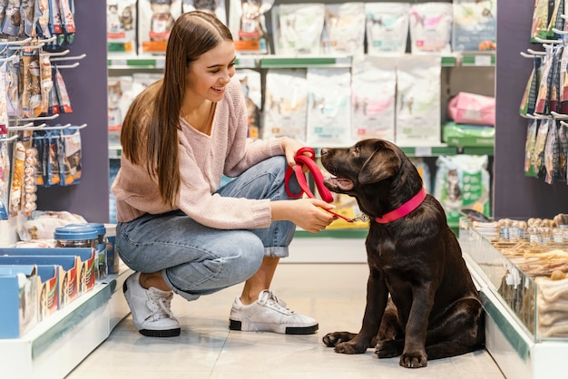 Adorable dog with female owner at the pet shop