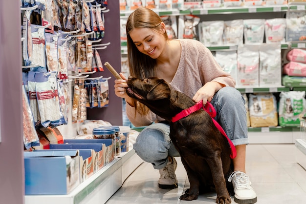 Free Photo adorable dog with owner at the pet shop