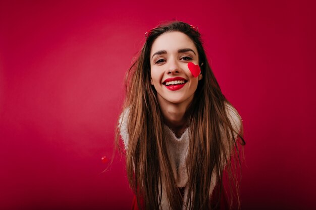 Adorable european girl with long hair expressing happiness in valentine's day