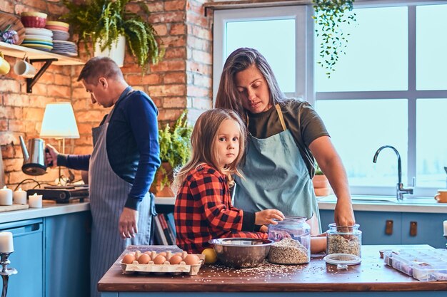 Adorable family together cooking breakfast in loft style kitchen.