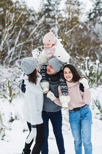 Free Photo adorable family in winter forest