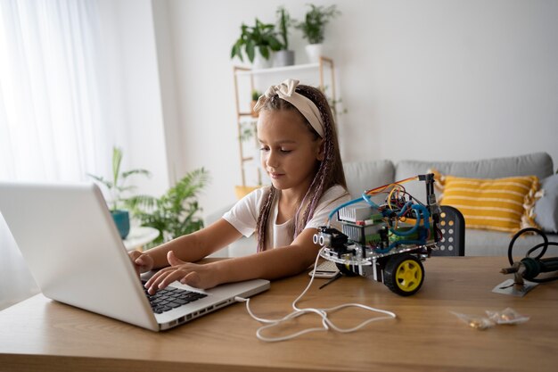 Adorable girl being passionate about robotics