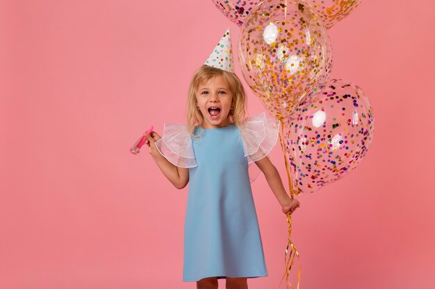 Adorable girl in costume with balloons