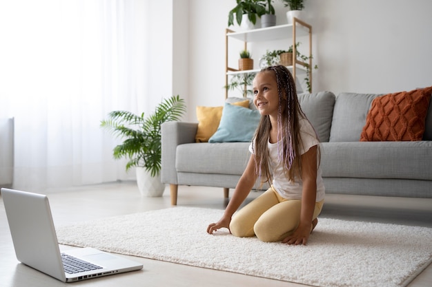 Free photo adorable girl doing yoga at home