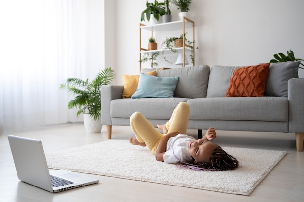 Adorable girl doing yoga at home