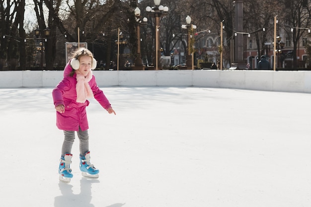 Free photo adorable girl ice skating outdoors