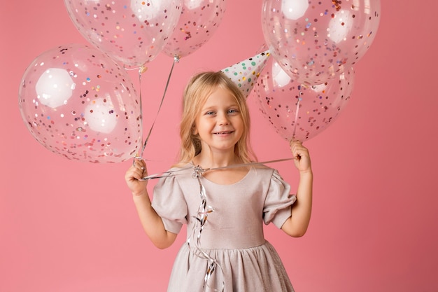 Adorable girl with balloons in costume