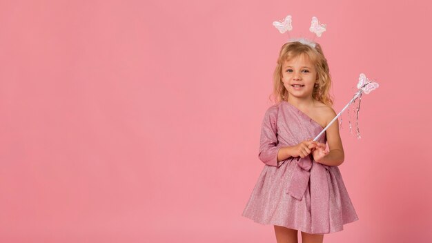 Adorable girl with fairy costume and copy space