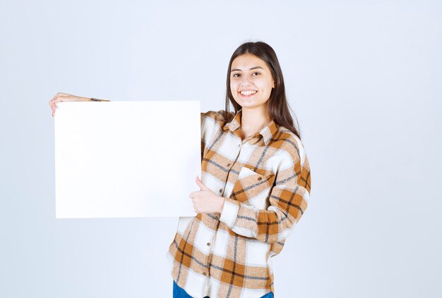  adorable girl with white big blank giving thumbs up. 