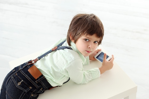 Adorable kid playing with a smartphone