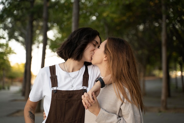 Adorable lesbian couple kissing outdoors