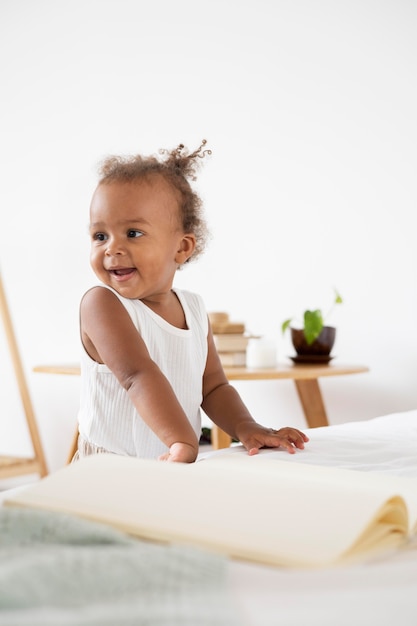 Adorable little black baby girl at home