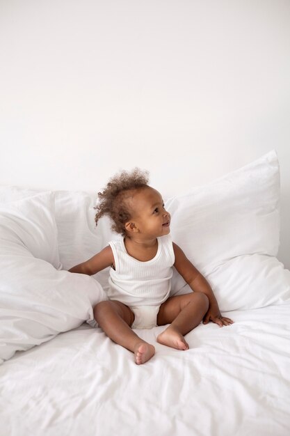 Adorable little black baby girl at home