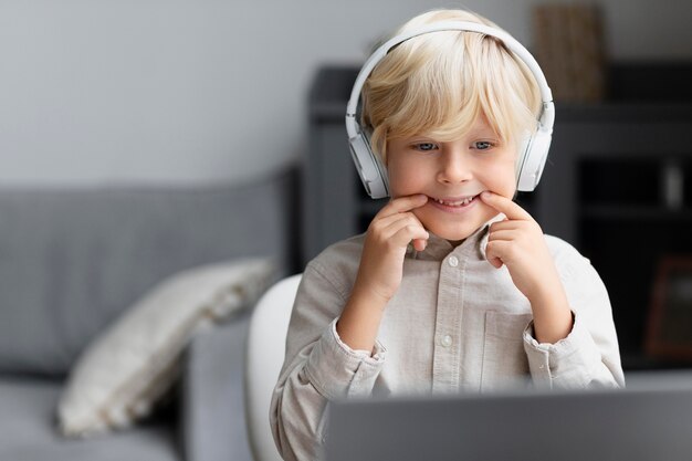 Adorable little boy doing an online session of speech therapy