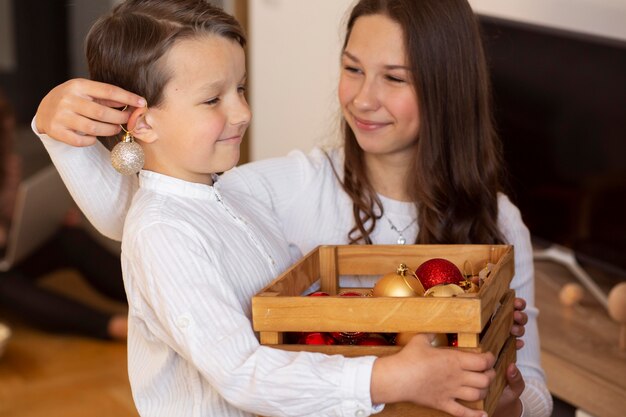 Adorable little boy with his sister on christmas