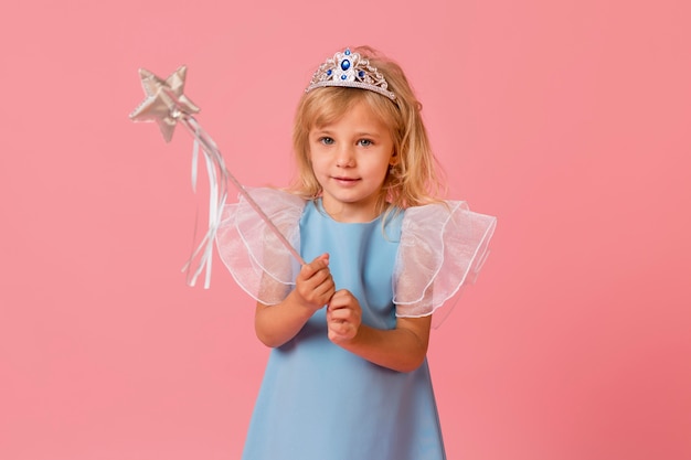 Free Photo adorable little girl in costume and wand