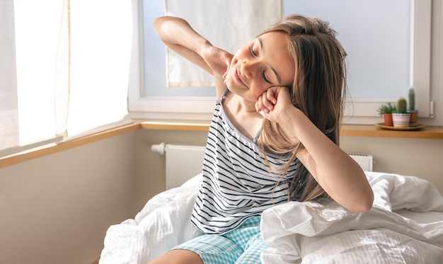 Adorable little girl in her bed early in the morning