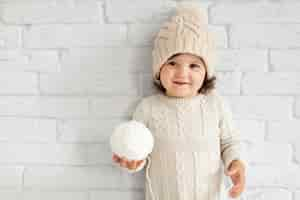 Free photo adorable little girl offering a snowball