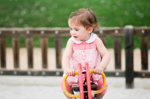 Adorable little girl playing in a urban park