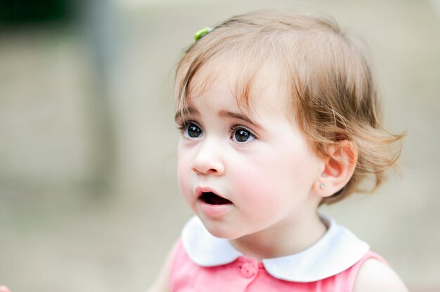 Adorable little girl playing in a urban park