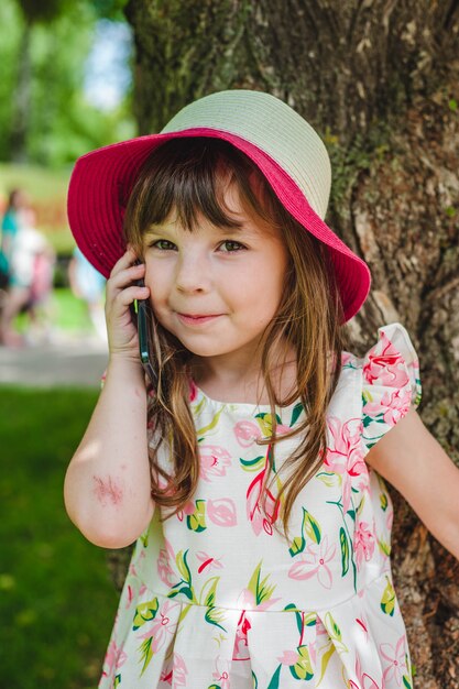 Adorable little girl talking on a mobile phone