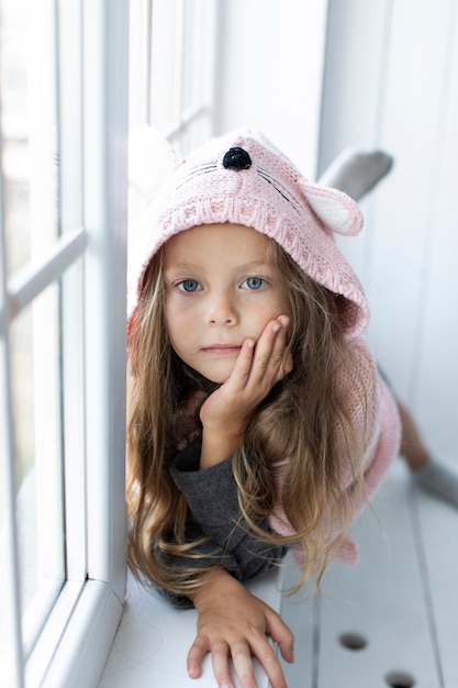 Free photo adorable little girl wearing pink pullover