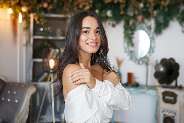 Free photo adorable model holding her hands to her shoulders and laughing to the camera high quality photo