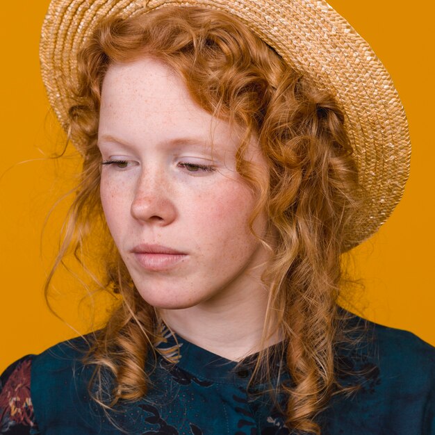 Adorable redheaded woman in studio