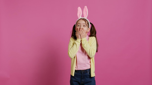 Free photo adorable surprised schoolgirl being in shock after seeing something in studio