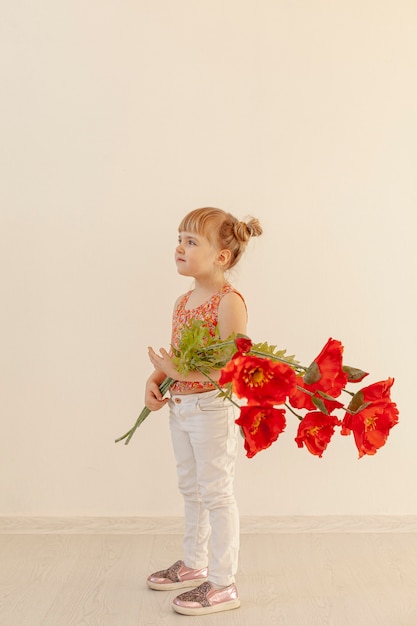 Free photo adorable toddler posing with flower