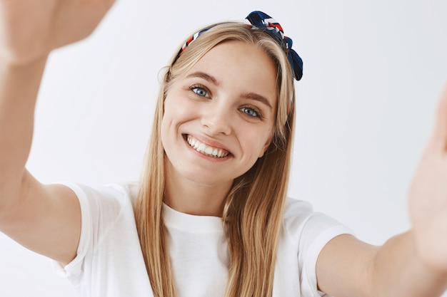 Free Photo adorable young blond girl posing against the white wall