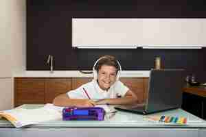 Free photo adorable young boy doing his homework