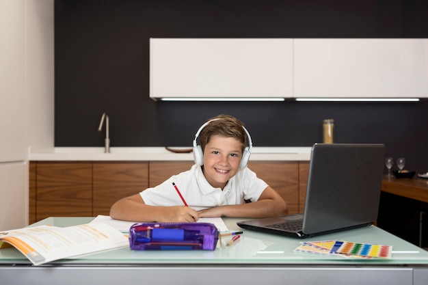 Free Photo adorable young boy doing his homework