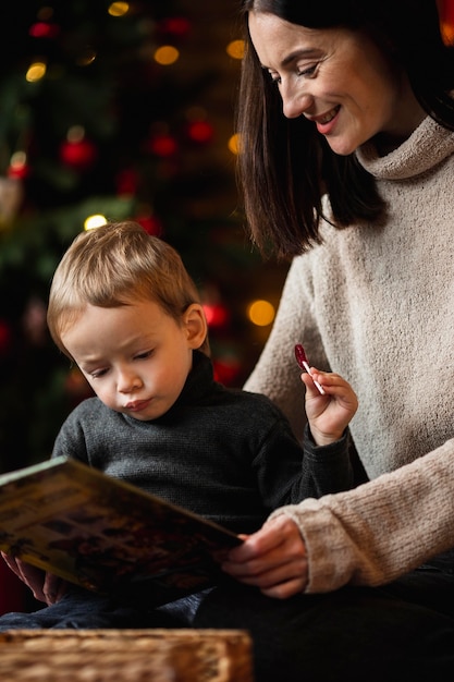 Free photo adorable young boy playing with christmas toys