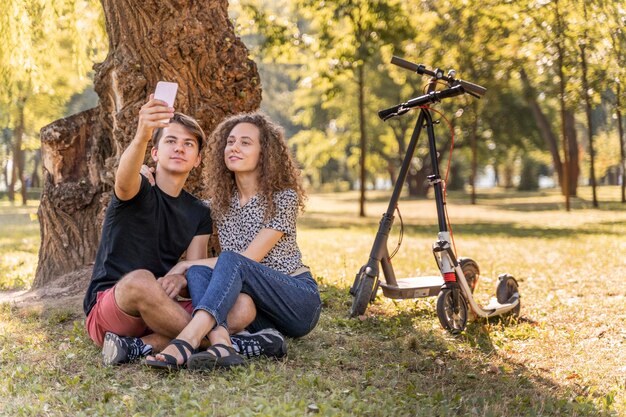 Adorable young couple taking a selfie outdoors