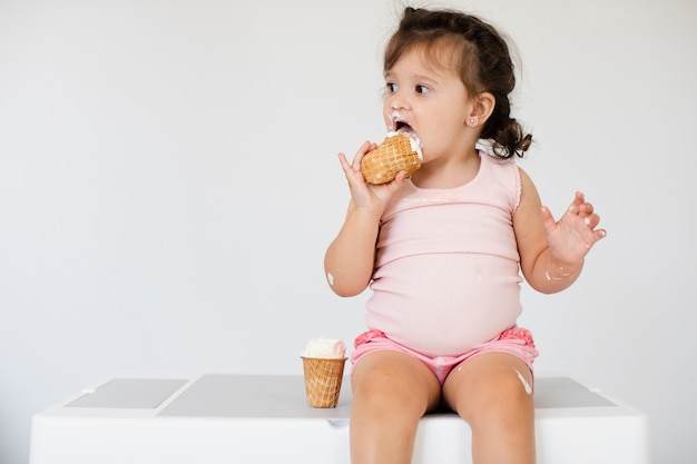 Adorable young girl eating ice cream