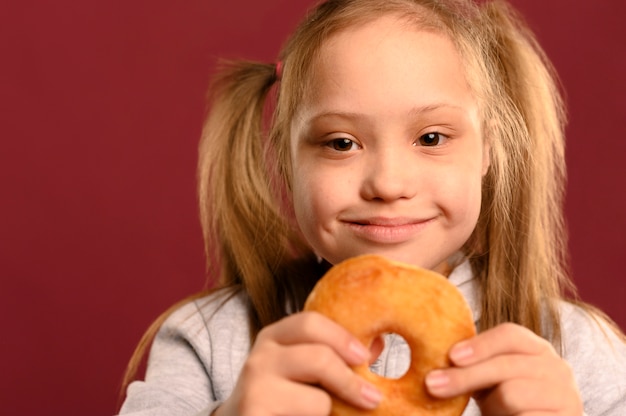 Free Photo adorable young girl holding delicious doughnut