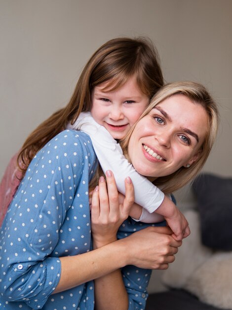 Adorable young girl playing with mother