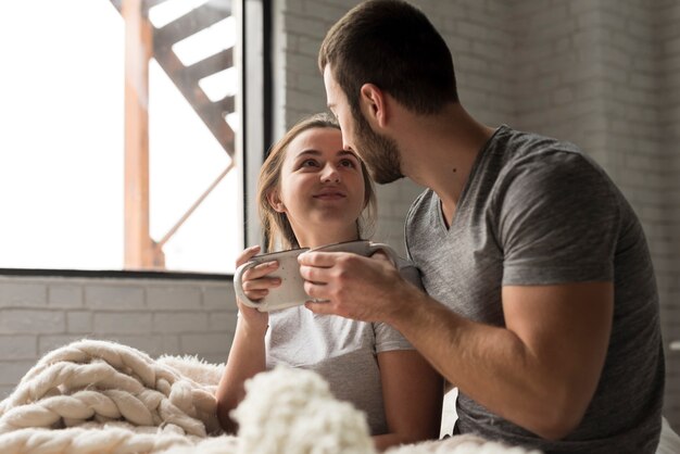 Adorable young man and woman having coffee