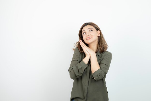 Adorable young woman in casual outfit standing and thinking. High quality photo