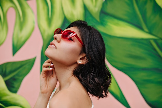 Adorable young woman posing in front of graffiti