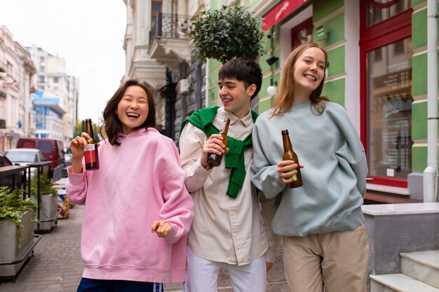 Adult friends drinking kombucha tea outdoors